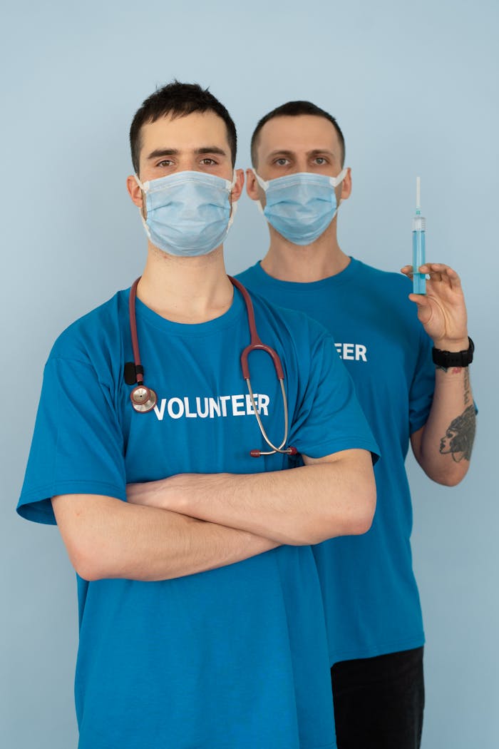 Man in Blue Crew Neck T-shirt Wearing White Face Mask